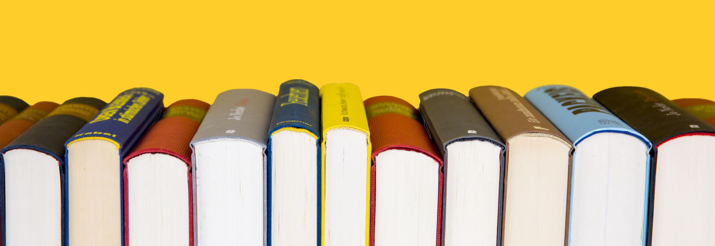 A row of books with a yellow background.
